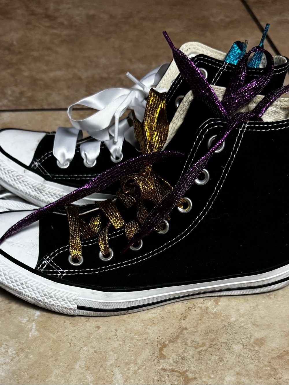 Converse Chuck Taylor Black High Tops with fun laces for flair.